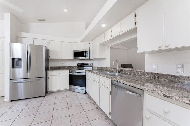 25046 Doredo Dr, Punta Gorda, FL 33955 - kitchen featuring appliances with stainless steel finishes, a sink, light tile patterned floors, white cabinetry, and recessed lighting