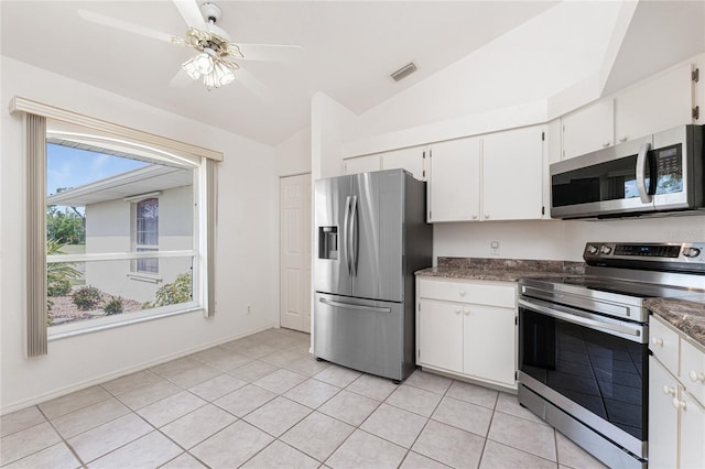 25046 Doredo Dr, Punta Gorda, FL 33955 - kitchen with appliances with stainless steel finishes, lofted ceiling, white cabinets, light tile patterned floors, and a ceiling fan