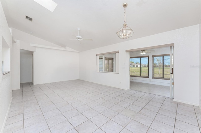 25046 Doredo Dr, Punta Gorda, FL 33955 - empty room with lofted ceiling, ceiling fan, a chandelier, and light tile patterned floors