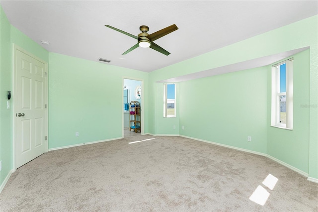 25046 Doredo Dr, Punta Gorda, FL 33955 - unfurnished bedroom featuring carpet floors, baseboards, multiple windows, and a ceiling fan