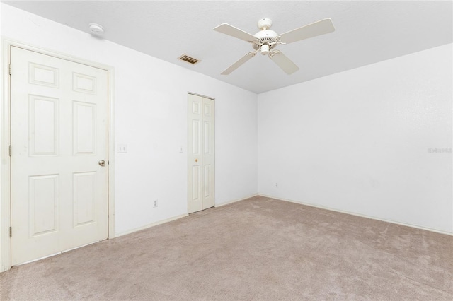 25046 Doredo Dr, Punta Gorda, FL 33955 - empty room featuring light colored carpet, ceiling fan, and a smoke detector