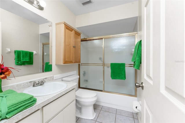 25046 Doredo Dr, Punta Gorda, FL 33955 - full bathroom with vanity, tile patterned floors, bath / shower combo with glass door, and toilet