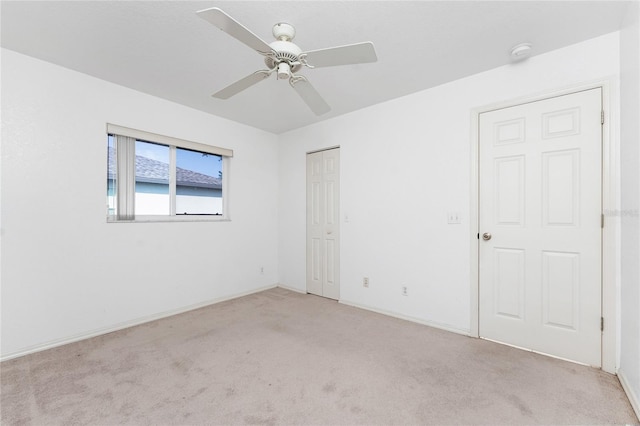 25046 Doredo Dr, Punta Gorda, FL 33955 - unfurnished bedroom with light colored carpet, a closet, a ceiling fan, and baseboards