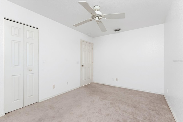 25046 Doredo Dr, Punta Gorda, FL 33955 - unfurnished bedroom featuring carpet floors, a closet, baseboards, and ceiling fan