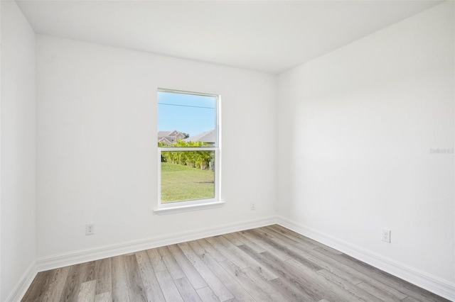 empty room with wood finished floors and baseboards