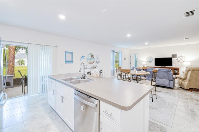 25324 Aysen Dr, Punta Gorda, FL 33983 - kitchen featuring dishwasher, a sink, a center island with sink, white cabinetry, and recessed lighting