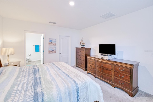 25324 Aysen Dr, Punta Gorda, FL 33983 - bedroom featuring light carpet, baseboards, and connected bathroom
