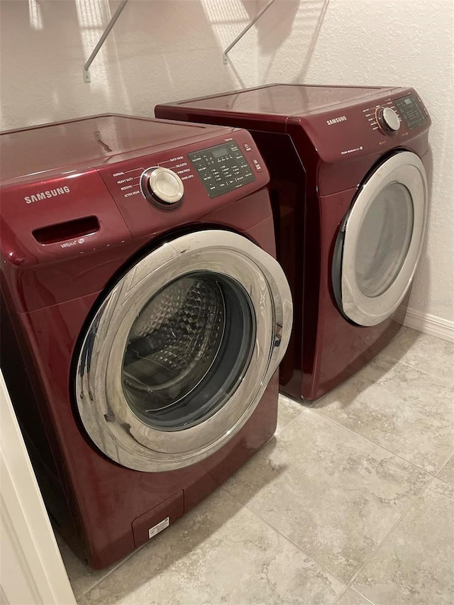 25324 Aysen Dr, Punta Gorda, FL 33983 - laundry area featuring washing machine and dryer and baseboards