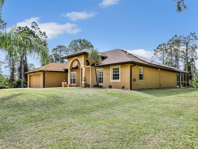8377 Mambo Ave, North Port, FL 34291 - view of front of home with stucco siding, an attached garage, solar panels, and a front yard