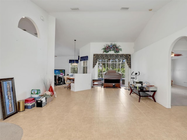8377 Mambo Ave, North Port, FL 34291 - living area featuring high vaulted ceiling, tile patterned floors, and arched walkways