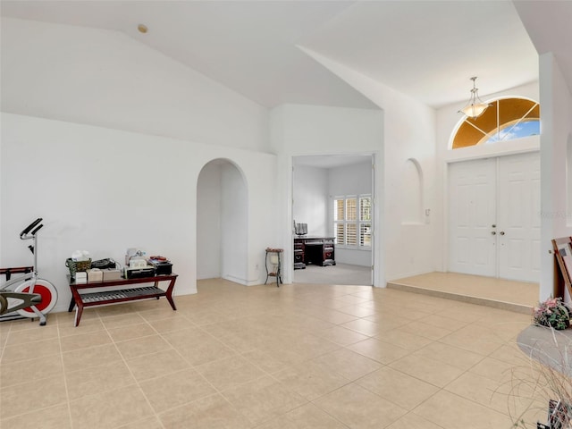 8377 Mambo Ave, North Port, FL 34291 - foyer entrance featuring arched walkways, light tile patterned flooring, and high vaulted ceiling