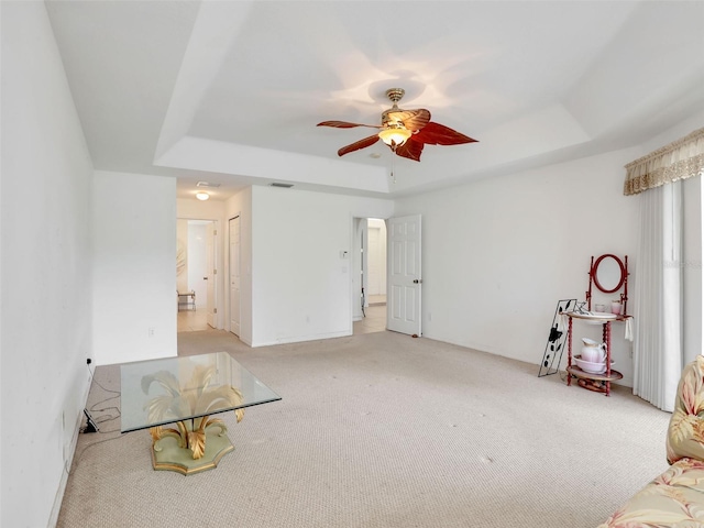 8377 Mambo Ave, North Port, FL 34291 - interior space featuring a tray ceiling, a ceiling fan, and light colored carpet