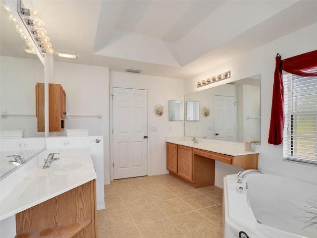 8377 Mambo Ave, North Port, FL 34291 - bathroom with a bath, two vanities, tile patterned floors, and a raised ceiling