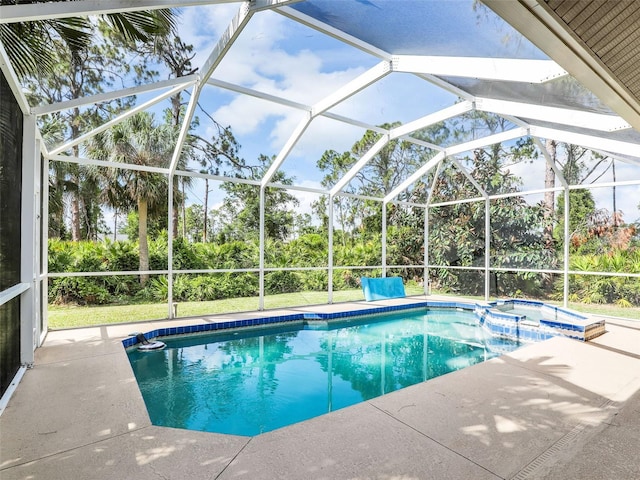 8377 Mambo Ave, North Port, FL 34291 - view of pool featuring a pool with connected hot tub, a patio area, view of scattered trees, and glass enclosure