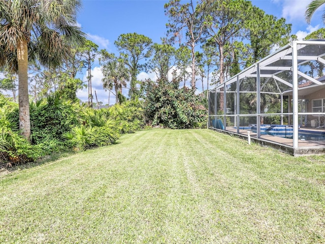 8377 Mambo Ave, North Port, FL 34291 - view of green lawn with an outdoor pool and glass enclosure
