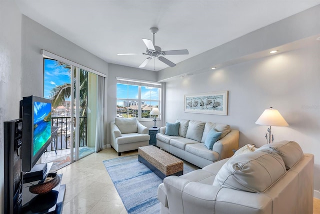 living room featuring a ceiling fan, recessed lighting, and baseboards