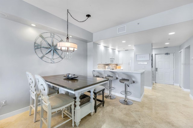 dining area featuring baseboards and recessed lighting