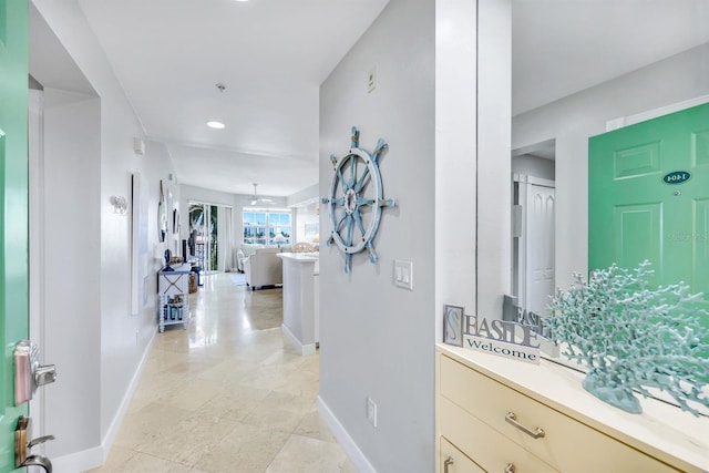 corridor with baseboards, recessed lighting, and light tile patterned flooring