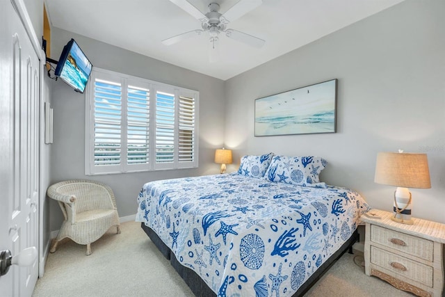 carpeted bedroom with baseboards and ceiling fan