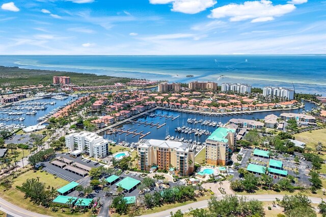 view of urban area featuring a marina and a nearby body of water