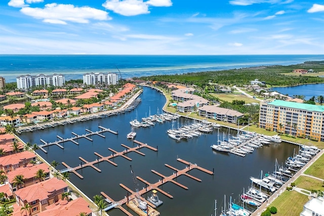 drone / aerial view of a marina and a nearby body of water
