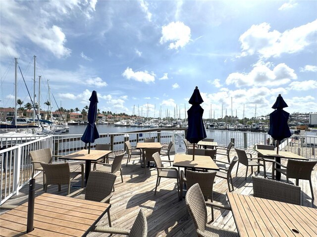 2090 Matecumbe Key Rd Unit 1404, Punta Gorda, FL 33955 - wooden deck featuring outdoor dining space and a water view
