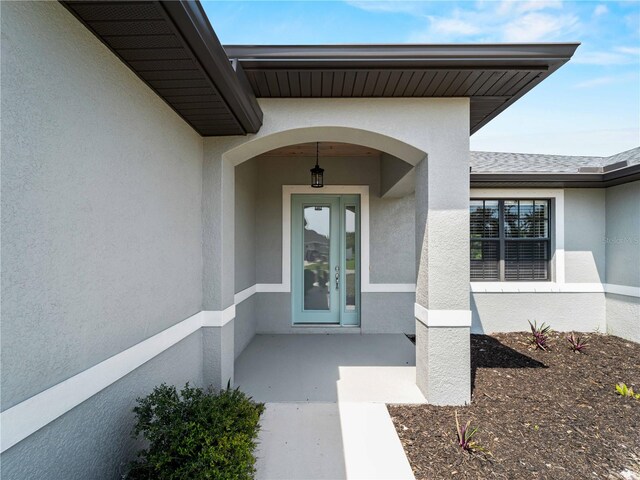 97 Pine Valley Ln, Rotonda West, FL 33947 - doorway to property featuring stucco siding