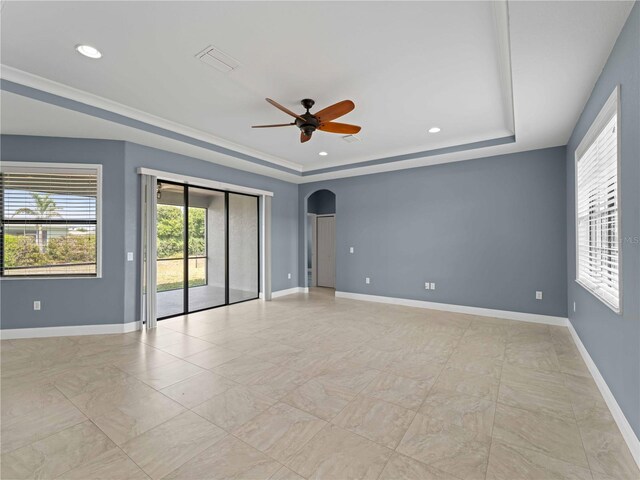 97 Pine Valley Ln, Rotonda West, FL 33947 - empty room with a raised ceiling, arched walkways, a ceiling fan, baseboards, and recessed lighting