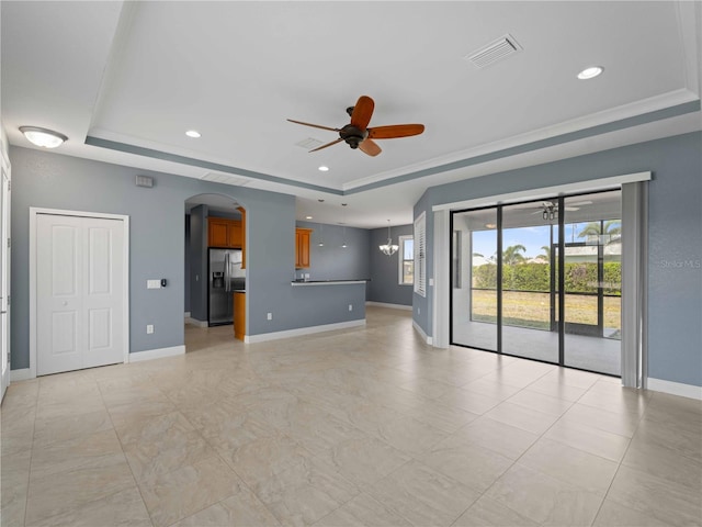 97 Pine Valley Ln, Rotonda West, FL 33947 - unfurnished living room with a raised ceiling, ceiling fan, arched walkways, and recessed lighting