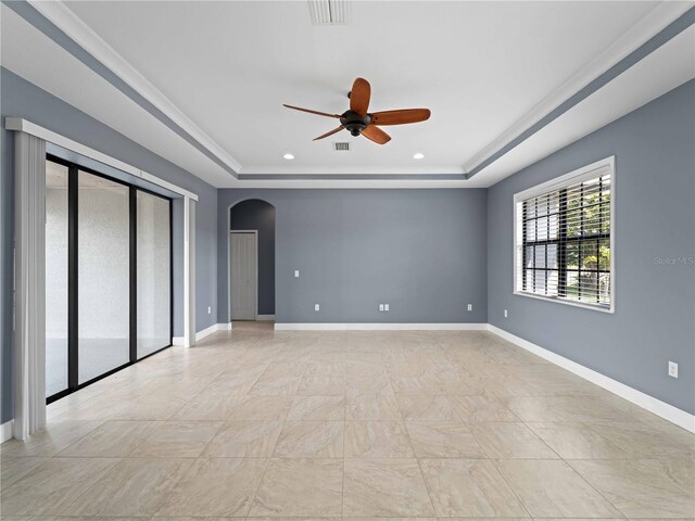 97 Pine Valley Ln, Rotonda West, FL 33947 - empty room with a raised ceiling, arched walkways, a ceiling fan, recessed lighting, and baseboards