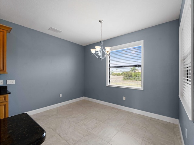 97 Pine Valley Ln, Rotonda West, FL 33947 - unfurnished dining area featuring a chandelier, baseboards, and light marble finish flooring