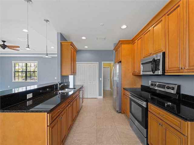 97 Pine Valley Ln, Rotonda West, FL 33947 - kitchen with appliances with stainless steel finishes, a sink, dark stone countertops, brown cabinetry, and recessed lighting
