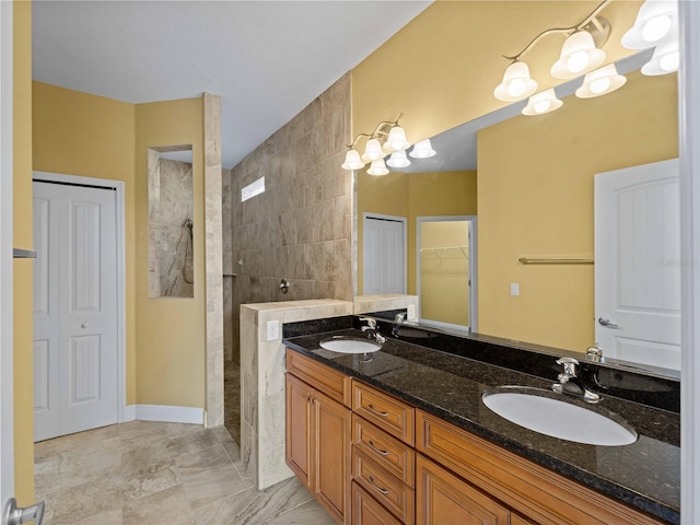 97 Pine Valley Ln, Rotonda West, FL 33947 - full bathroom featuring walk in shower, double vanity, a walk in closet, and baseboards