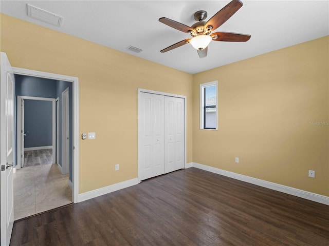 97 Pine Valley Ln, Rotonda West, FL 33947 - unfurnished bedroom featuring wood finished floors, baseboards, and a closet