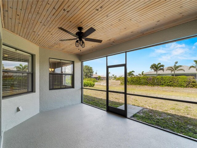 97 Pine Valley Ln, Rotonda West, FL 33947 - unfurnished sunroom with a ceiling fan
