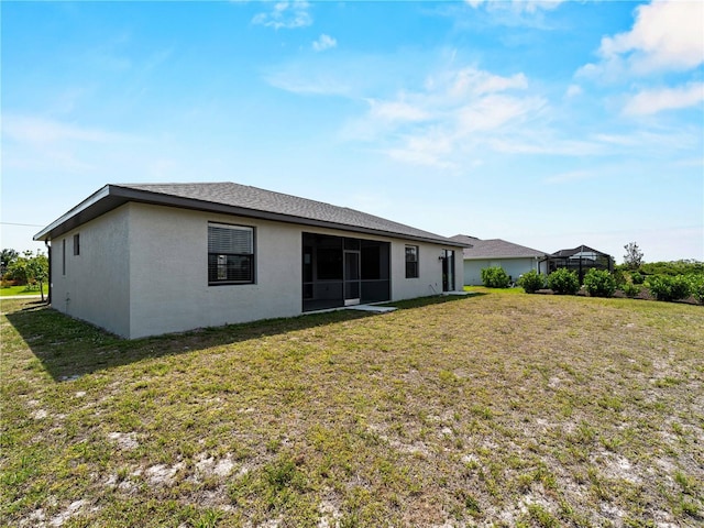 97 Pine Valley Ln, Rotonda West, FL 33947 - rear view of house with a lawn and stucco siding