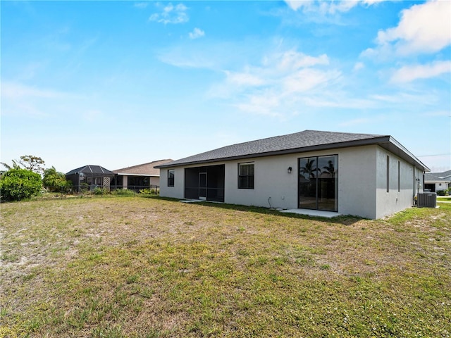 97 Pine Valley Ln, Rotonda West, FL 33947 - rear view of house with a yard, stucco siding, and central AC