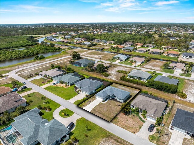 97 Pine Valley Ln, Rotonda West, FL 33947 - aerial view of property's location with a large body of water and nearby suburban area