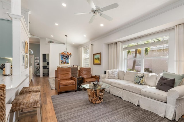 living room with crown molding, recessed lighting, plenty of natural light, ceiling fan, and a chandelier
