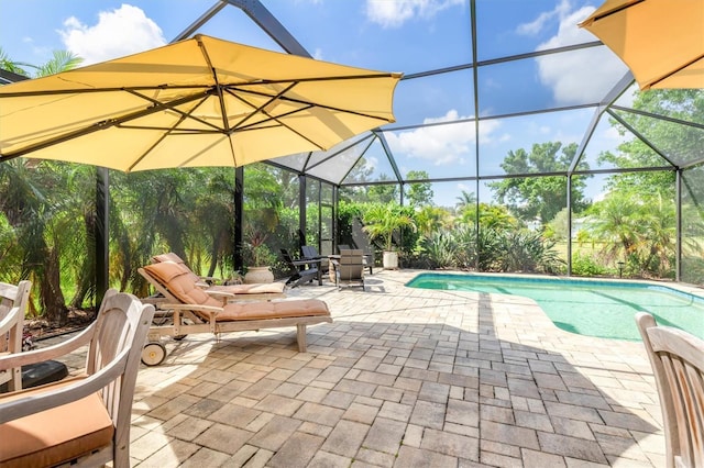 swimming pool featuring a patio and glass enclosure