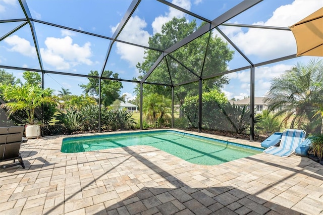 swimming pool with a patio area and a lanai
