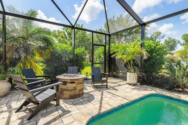 outdoor pool featuring a fire pit, a patio, and a lanai