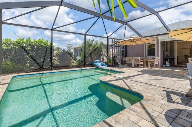 swimming pool featuring a patio, outdoor dining space, and a lanai