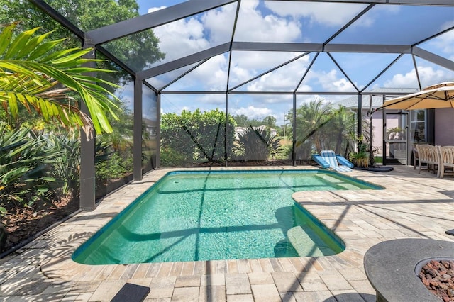 swimming pool featuring a patio and glass enclosure