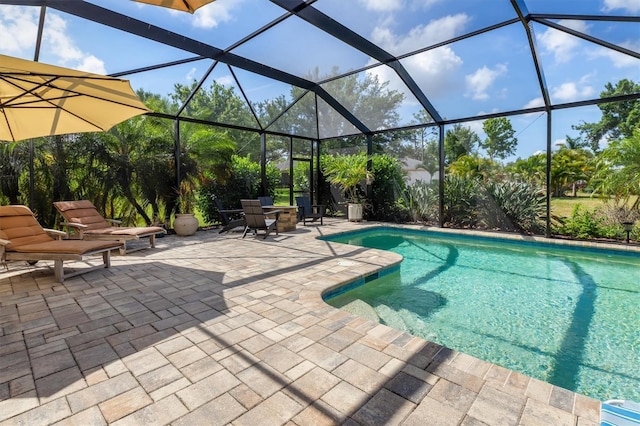 swimming pool with a patio and glass enclosure