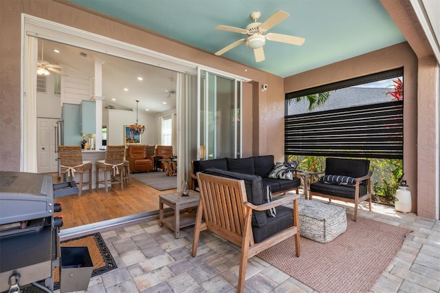 view of patio featuring a ceiling fan and an outdoor living space