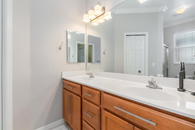 bathroom featuring crown molding, double vanity, a stall shower, and baseboards