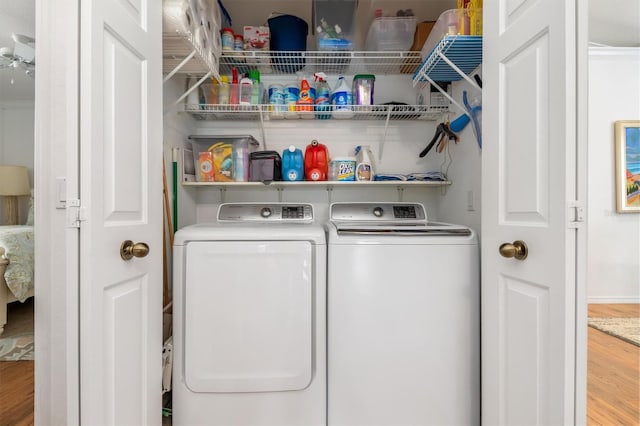 laundry room featuring separate washer and dryer and wood finished floors