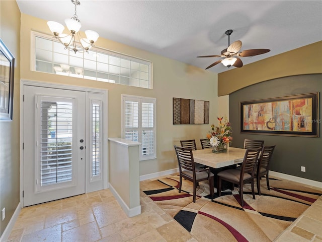 11982 Granite Woods Loop, Venice, FL 34292 - dining room with a chandelier, baseboards, ceiling fan, and stone tile floors
