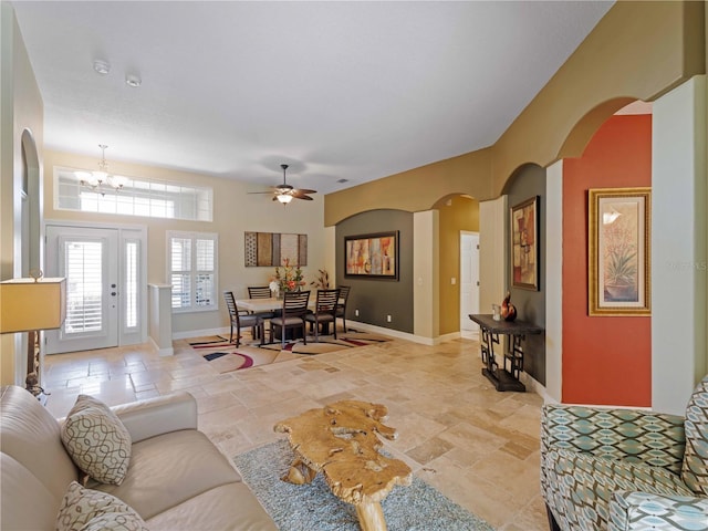 11982 Granite Woods Loop, Venice, FL 34292 - living area featuring ceiling fan, stone tile floors, a chandelier, baseboards, and arched walkways